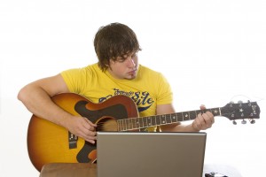 young man plays guitar